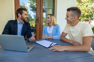 Real estate agent discussing deal details with the clients