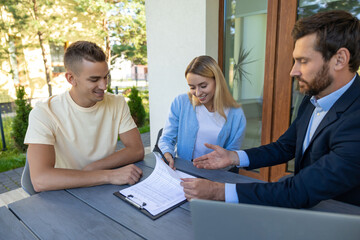 Real estate agent discussing deal details with the clients