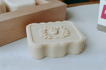 Handmade Soap Bar with Decorative Relief in Neutral Tones on Surface. Mock up promotion information for marketing announcements and details, blank white space