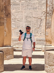 Tourist taking photos in the temple of seti i at abydos, egypt