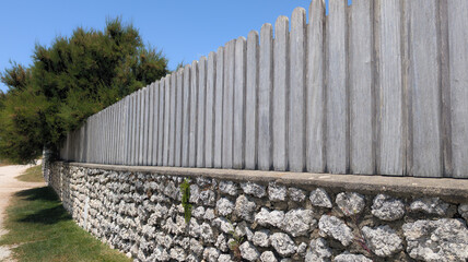 wall planks wooden fence with stones structure street wood barrier private house protect view and access home garden