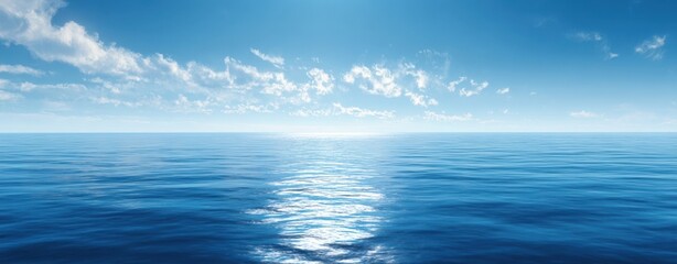 Fototapeta premium The serene ocean with endless reflections under a bright blue sky