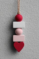 Kawaii wooden bead garland featuring red and pink beads crafted for home decoration. Valentine's Day