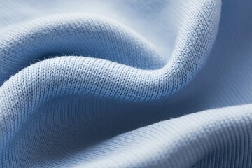 Close up macro shot of soft light blue knitted fabric with gentle folds and texture