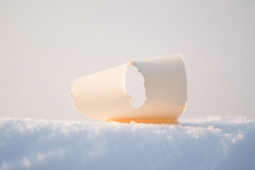 A single paper cup rests on a surface of soft puffy clouds against a light colored background