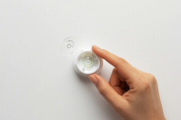x-default Woman's hand holding a contact lens case