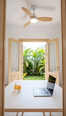 Modern workspace with tropical garden view laptop drink