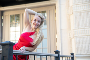 slim fashion blonde in red evening dress