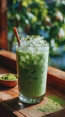 Fototapeta premium Refreshing iced matcha latte with ice cubes and natural lighting on a wooden table