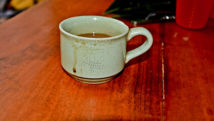 close up view of coffee cup on brown table