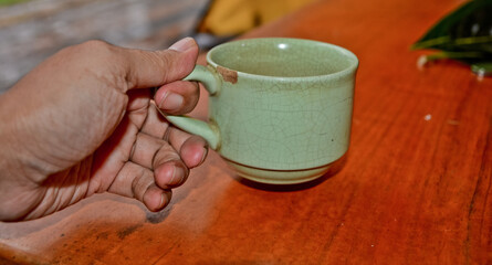 close up view of coffee cup on brown table