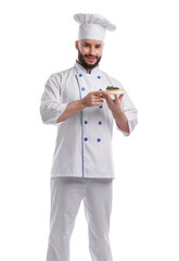Happy confectioner in uniform holding delicious tart with blueberries on white background