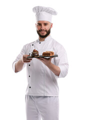 Happy confectioner in uniform holding delicious chocolate desserts on white background