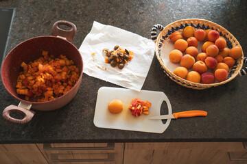 chopping and preparing apricots for homemade jam