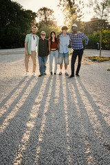 Full length portrait of a happy diverse group of young friends standing together. Concept of...