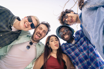 A diverse group of young friends joking and making funny faces for a selfie. Concept of authentic...