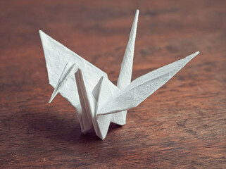 Origami Crane on Wooden Table.
