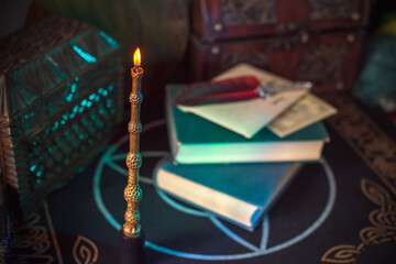 Magical books on a table, magic candle wand, concept of fairy tales