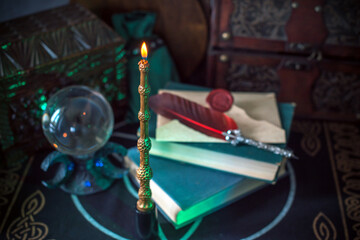 Magical books on a table, magic candle wand, concept of fairy tales