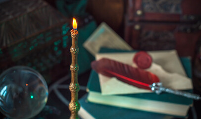 Magical books on a table, magic candle wand, concept of fairy tales