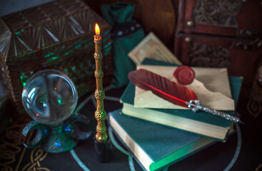Magical books on a table, magic candle wand, concept of fairy tales
