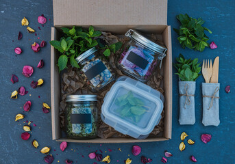 Eco-friendly food delivery box with reusable containers and herbs