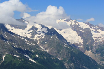 mountain peaks in the clouds North Caucasus Dombay Elbrus region midsummer