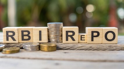 Blurred RBI REPO text with percentage figures and coins arranged on wooden blocks
