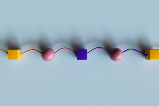 3D render of abstract spheres and cubes linked in a colorful geometric design
