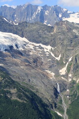 melting glaciers flowing into small rivers in the North Caucasus mountains in Dombai in midsummer