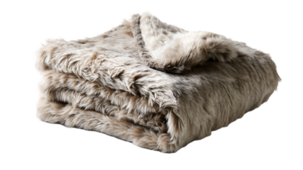 A folded faux fur blanket in neutral tones sits on a dark surface with a soft and inviting texture