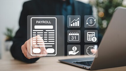 Person touching payroll icons on laptop for efficient business operations