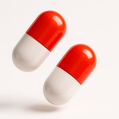 Two red and white capsules are isolated on white background