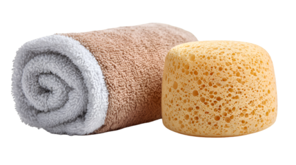 A rolled towel with white and beige colors next to a yellow sponge on a plain black background