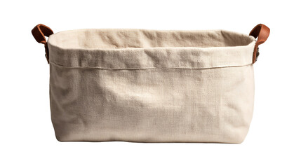 A close up of a rectangular beige fabric storage basket with brown leather handles on a black background