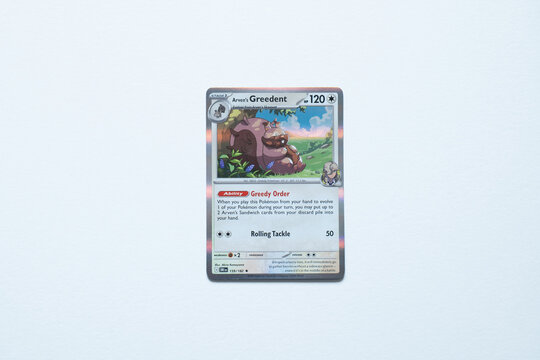 Arven's Greedent pok&eacute;mon trading card shot on a white paper background. Bradford, UK, Jul 10 2025