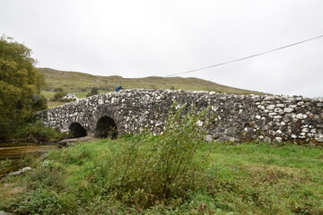 Historic stone bridge over a stream near Tongue village, Sutherland, Highlands of Scotland. Typical...