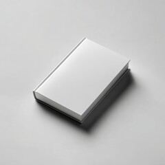 Fototapeta premium Minimalist studio shot of a closed hardcover book with a blank white dust jacket, placed at a slight angle on a light gray background, no text or graphics, clean product mockup