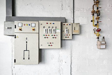 Electrical Control Panels Mounted on Textured Concrete Wall.