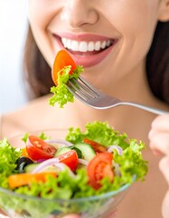 Close-up of a woman enjoying a colorful salad, with focus on her smiling mouth and forkful of fresh vegetables. A vibrant and healthy eating concept perfect for lifestyle, wellness, or nutrition theme