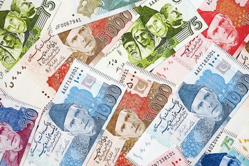 Pakistan rupees banknotes. The current Pakistan money bills lies on table in big amount