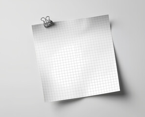 Blank squared paper sheet clipped with metal binder against white background in minimalist office stationery flat lay

