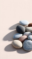 Collection of smooth, colorful pebbles arranged artistically on a soft surface, showcasing natural textures and shadows, perfect for backgrounds or decorative elements in design projects