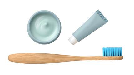 Overhead view of a bamboo toothbrush with blue bristles, a tube and a container of toothpaste