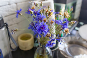 vase with a bouquet of blue flowers cornflowers close-up, photo background, space for text