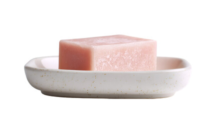 A close up of a pink soap bar on a speckled white ceramic soap dish against a black background studio shot