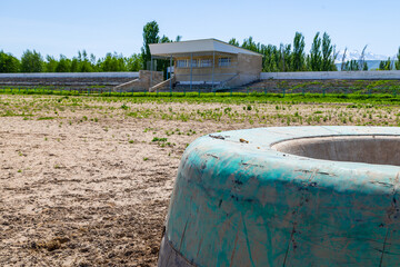 Green kazan in Kok-Boru stadium at sunny summer day.