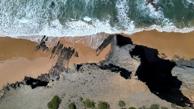 Aerial view of Praia da Barriga beach and cliffs, Portugal.