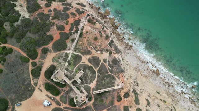 Aerial view of historical ruins on a rocky cliff, Portugal.