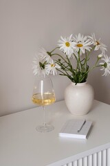 Refreshing Vision A Beautiful Bunch of Pure White Daisies Alongside a Glass of Fine Wine